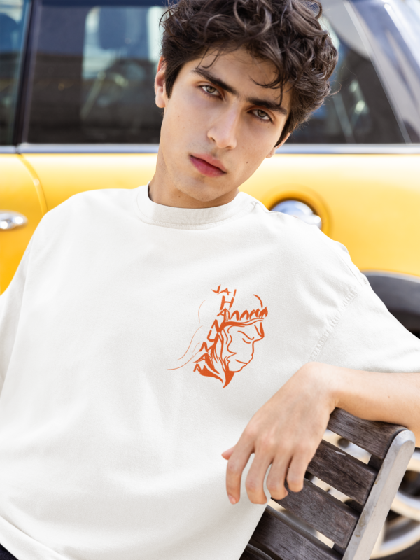 oversized tee mockup of a man sitting on a street bench and posing with a serious look m55820